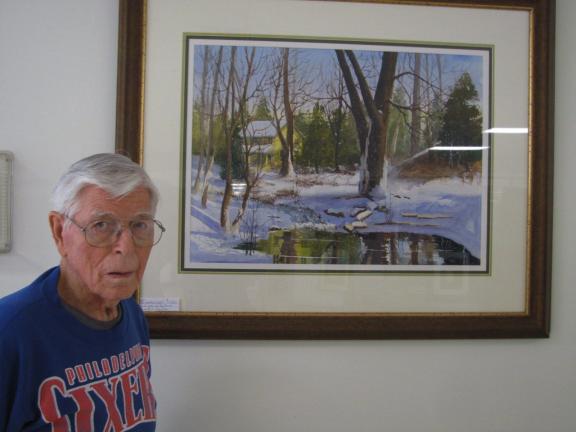 Bill Wentz, who taught at the Baum School of Art and mentored many members of the art league, stands by his painting "Winter on the Farm."