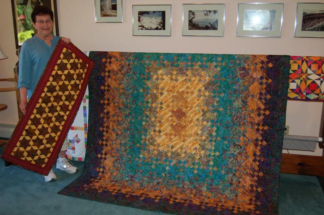 LINDA KOEHLER/TIMES NEWS Diane Minor, Albrightsville, will be the featured quilter at the Polk Township Historical Society's 12th Annual Stitch in Tyme quilt show. Some of her work to be displayed includes the Woven Stars table runner she is holding…