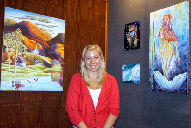 ANDREW LEIBENGUTH/TIMES NEWS Meghan Dailey, 17, stands with some of her work on display at Stonehedge Gardens.