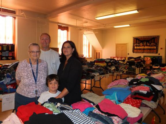 STACEY SOLT/TIMES NEWS Helping to organize clothing for St. John's annual clothing giveaway are, from left, Miriam Borosh, Luther Snyder, Asher Huffaker, 5, and Bonnie Hoffman. The annual giveaway will start this Thursday at 9 a.m. and continue on…
