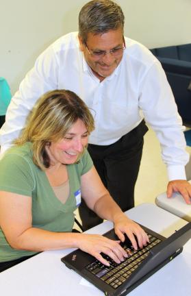 ANDREW LEIBENGUTH/TIMES NEWS Connie Smith, Lehighton, receives assistance from Jim Mathiesen, Regional Health Initiative Director, Eastern Region, ACS, during a study held at the LCCC campus in Tamaqua.