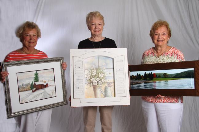 SPECIAL TO THE TIMES NEWS Three of four prizes to be awarded at the Concourse Club of Palmerton's Annual Community Festival Art and Photography Show include, from left, a watercolor winter scene by Margaret Kuhet, held by Kuhet; a shuttered window…