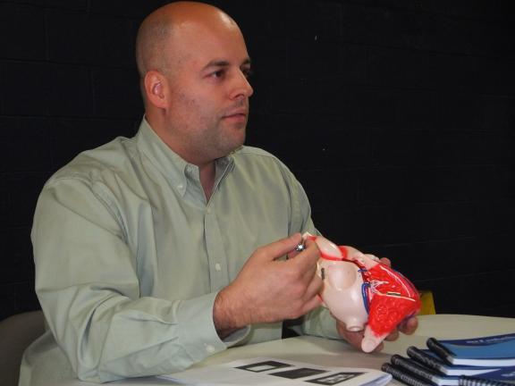 Stacey Solt/Special to the Times News Dr. Christopher Cutitta uses a model of the heart to explain types of heart disease.