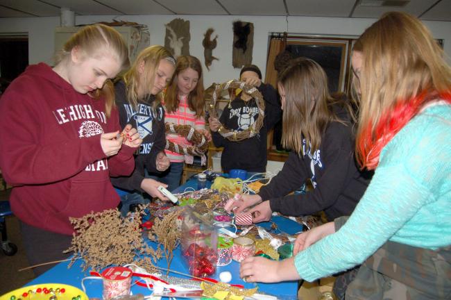 TERRY AHNER/TIMES NEWS Members of Girl Scout Troop 3580 work on their Christmas crafts as part of an event hosted recently by the Carbon County Environmental Education Center in Summit Hill.