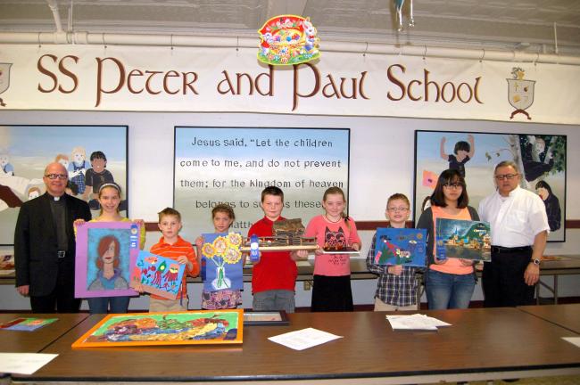 Gail Maholick/TIMES NEWS First place winners of the District 5 Catholic Youth Organization (CY0) annual Arts and Crafts Show are, from left, the Rev. Mike Ahrensfield; Kelci Bubser, William Behun, Megan Matsko, Jacob Shelton, Shannon Dougherty,…