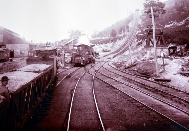 Coal cars, left, wait to be hoisted from the foot of the Mahanoy Plane in this 1890s image.