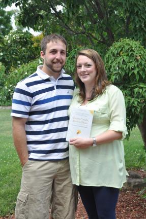 AMY MILLER/TIMES NEWS Charles and Drewann Troutman hold the book "Empty Cradle, Broken Heart." The book helped them through the passing of their son Bennett. They now donate these books to St. Luke's Hospitals through their nonprofit organization…