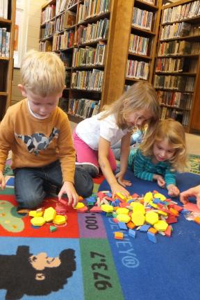 Stacey Solt/Special to the Times News In a world filled with technology, low-tech toys are still popular and make a great holiday gift for children and teens. From left, 3-year-olds Zachary Goodhile, Eliza Rodgers and Quinn Haydt, all of Lehighton,…