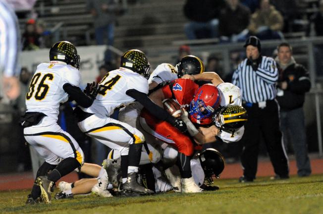 nancy scholz/special to the times news North Schuylkill's John Rupinski is tackled by a host of Northwestern defenders, including Taylor Breininger (7), Joseph Colucci (24), Teagen Golden (22) and Andrew Sorensen (86).