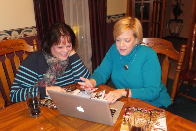 Stacey Solt/Special to the Times News ABOVE: Tina VanBuren, left, and Lisa Johnson look through sale  fliers as they prepare for Black Friday. The Tamaqua friends have been shopping on Black Friday for more than 15 years.  RIGHT: In this Nov. 28,…