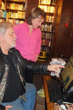 Stacey Solt/Special to the Times News Mariann Kmetz, the director of the Dimmick Memorial Library in Lehighton, answers a question for David Holmes of Nesquehoning at the library's public computers. When sharing financial information online, or…