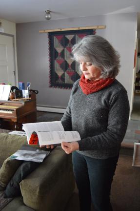 @$:Marcia Evans thumbs through a copy of The Sun, a literary magazine known for its  well-written and thought-provoking essays.