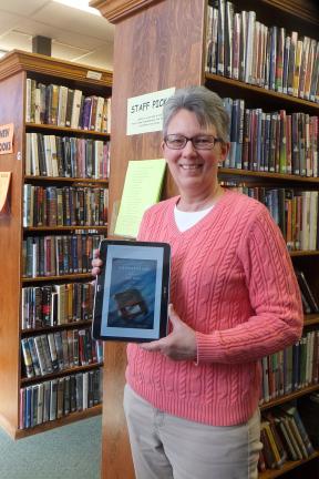 Stacey Solt/Special to the Times News Diane Danielson, the librarian at Palmerton Area Public Library, with an electronic copy of "Shakespeare Saved My Life." The book is being offered as part of a worldwide electronic book club, which is open to…