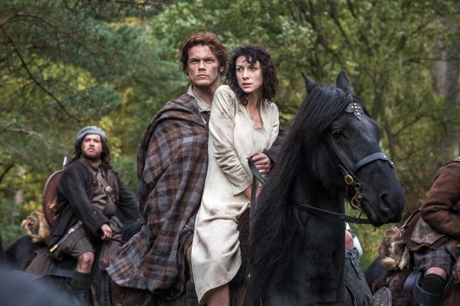 This photo released by Sony Pictures Television shows Caitriona Balfe as Claire Randall, right, and Sam Heughan as Jamie Fraser, center, and Grant O'Rourke as Rupert MacKenzie, in a scene from Starz' new TV series, "Outlander." (AP Photo/Sony…