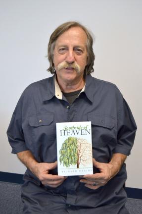 KAREN CIMMS/TIMES NEWS  Author Richard Wright holds a copy of his new book, "Southside of Heaven."