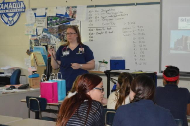 Tiffany Bieber RN shows the students some of the medical equipment used by nurses as they monitor a patient's vital signs.