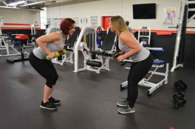 Circuit 1: Tricep kickbacks, using 3- to 8-pound weights. Stand in a partial squat, back straight, elbows in with the weights close to your body.