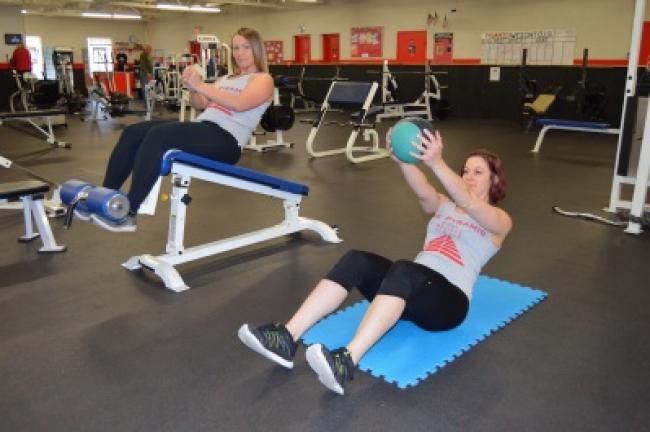 Circuit 2: Russian twists, using no weights with hands clasped or up to 3-pound weighted ball. Sit on the floor or on a slant board with your arms extended in front of you, hands clasped or holding the weighted ball.