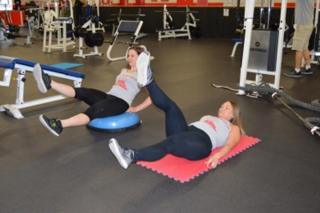 Circuit 2: Flutter kicks. Lie on the floor, head and shoulders angled upward, or seated on a BOSU balance trainer, with your legs straight. Flutter kick 40 times.
