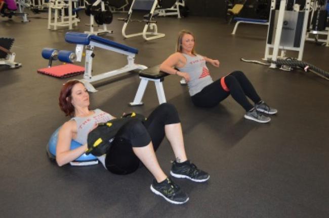 Circuit 3: Hip thrusts, using resistance bands above your knees or a weight over your stomach, and resting on a BOSU or an exercise bench.