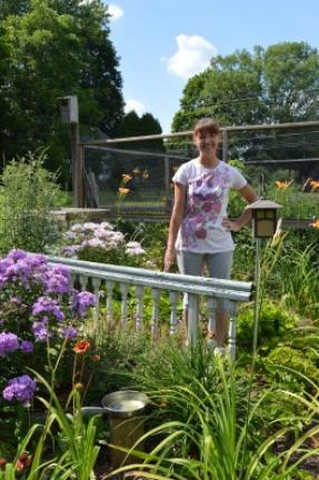 Cheryl Freundt stands in the butterfly garden at her Franklin Township home. The balustrade in front of her matches the one her friend Julie Graver has. Graver's garden was featured in the Home section July 22. KAREN CIMMS/TIMES NEWS