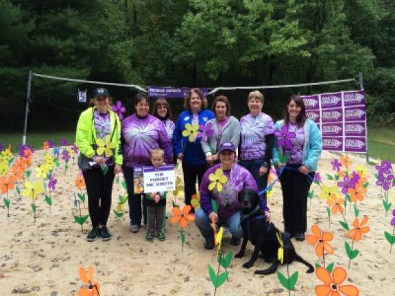 The group of Forget Me Knots stop for a picture in the Promise Garden during the 2016 Walk to End Alzheimer's - Carbon County. Front, from left, are Parker Derr and Grace Kern, who is kneeling with Shadow. Standing: Emily Roxburry, Tara Derr, Tami…