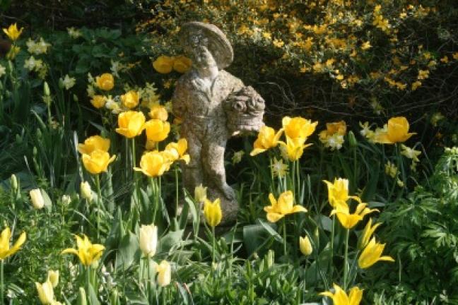 This April 19, 2009 photo taken in a private garden in rural Belgium demonstrates how eye-catching statuary can be used to personalize flower gardens. Garden antiques can be made of wicker, metal or stone and range from pergolas to fountains,…