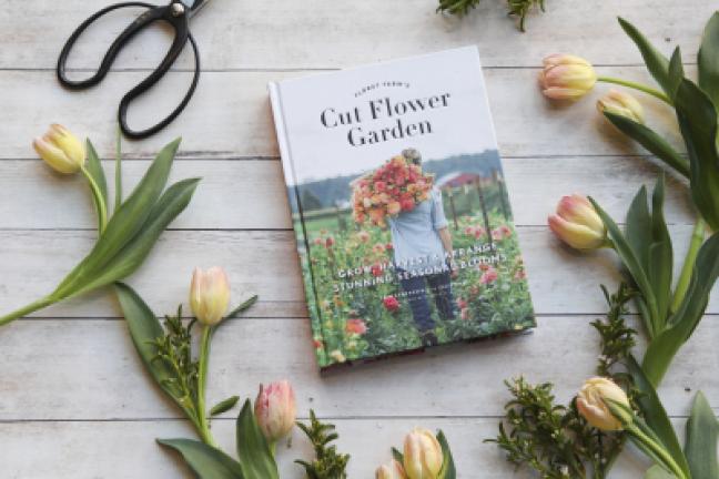 This photo provided by Chronicle Books shows Erin Benzakein's book, "Floret Farm's Cut Flower Garden," and is surrounded by tulips, one of the first bloomers each spring, in San Francisco, California. IRENE KIM/CHRONICLE BOOKS VIA AP Copyright -…