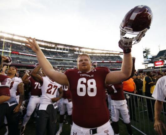 Temple offensive lineman and Marian High School graduate Brendan McGowan (68) celebrates after Saturday's win over Penn State. AP PHOTO