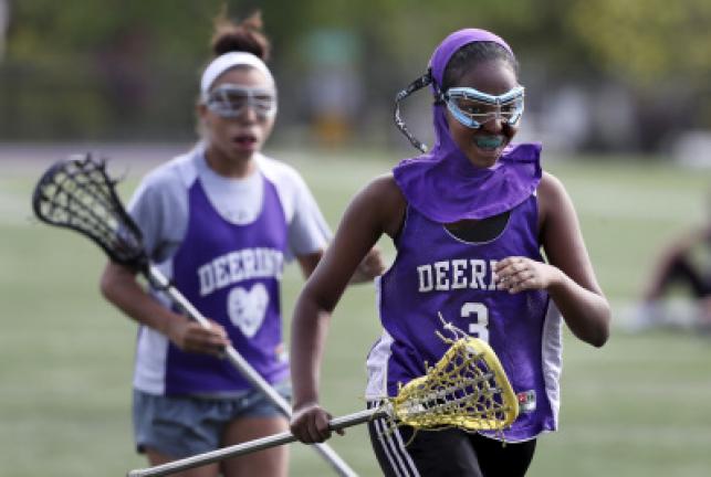 In this May 24, 2017 photo Fadumo Adan, a lacrosse player at Deering High School, wears a sports hijab provided by the school during practice in Portland, Maine. Deering High School is providing sport hijabs with the goal of making Muslim girls…