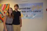 KAREN CIMMS/TIMES NEWS Michelle Zenie, left, executive director of the Pediatric Cancer Foundation of the Lehigh Valley, and son Cole, stand near a sign recognizing September as Pediatric Cancer Awareness Month. Cole is a 12-year survivor of leukemia.