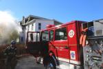 Tamaqua firefighters battle a house fire Wednesday at a building located atop the retaining wall of the Little Schuylkill River. Meanwhile, just a few steps behind the fire engine seen here, one or two young thieves were busy stealing up to $15,000…