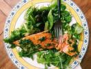 This warm-weather recipe combines salmon bathed in olive oil and herbs with spring-y greens and salad. It's the kind of lighter, brighter meal we tend to want during summer. AP PHOTO/KATIE WORKMAN