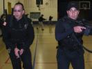 KATHY KUNKEL/TIMES NEWS Tamaqua Police Officers Matt Bynon (left) and Tom Rodgers search for an armed gunman seen near the east side of the gym during a drill at the Tamaqua Elementary School on Monday. Searching the western side of the gym, in the…
