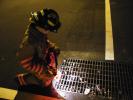 ANDREW LEIBENGUTH/SPECIAL TO THE TIMES NEWS Lansford junior firefighter Cale Staruch inspects a street drain for a smell or sign of fuel.