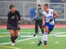 BOB FORD/TIMES NEWS Pleasant Valley's Felicia Domenici (4) moves the ball down the field away from Bangor's London Dickey during Tuesday's 3-2 overtime win in District 11 3A field hockey play.