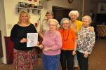 AMY ZUBEK/TIMES NEWS The women of the Lehighton Hi-Rise Craft Club recently presented Joan Kennedy, left, with a monetary donation to help cover the expenses of the Christmas package campaign for 1,000 U.S. Marines and Sailors in the 2nd Battalion…