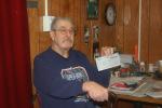 CHRIS PARKER/TIMES NEWS Navy veteran Richard McGinley, 73, of Lehighton, holds the "sweepstakes" check he received in the mail.