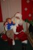 Nolan Strauss, 14 months old, son of Steve and Jen Strauss of Franklin Township, enjoys two traditional Christmas favorites - the candy cane and Santa Claus. It was his first experience with santa.