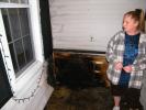 andrew leibenguth/special to the times news Fire victim, Brenda Krynock of 251 E. White St, looks over some of the fire damage to her home and back porch.