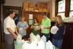 KAREN CIMMS/TIMES NEWS Students in the confirmation and senior classes at St. John's Lutheran Church, in the heights section of Jim Thorpe, make luminarias for the Live Nativity. After holes are cut into the milk jugs, they will be placed around the…