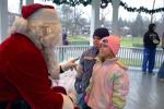 TERRY AHNER/TIMES NEWS Jessica Heydt, 3, and Lucas Heydt, 5, of Lehighton, talk with Santa during his visit to the Palmerton Borough Park on Saturday.