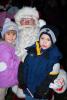 Kate Halenar, left, 4, and Ronnie Snyder, 5, both of Lehighton, get a hug from Santa during his visit to Lehighton Park Amphitheater on Friday.
