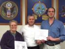 Two members of the Carbon County Special Olympics Management Team, Joan Kostro, left, and Chris Anthony, right, were recently recognized statewide for their efforts. Presenting them awards are William O'Gurek, manager of the local management team.