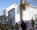 ANDREW LEIBENGUTH Smoke pours from an upstairs bedroom window in Coaldale Sunday afternoon.