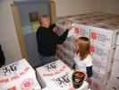 ANDREW LEIBENGUTH/SPECIAL TO THE TIMES NEWS Tamaqua Police Chief George Woodward, left, and Tamaqua Marketing Class volunteer Shauna Bannan help distribute Tamaqua Salvation Army food boxes and hams during the Tamaqua Salvation Army distribution.