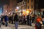 A large crowd gathers on a snowy East Broad St in Tamaqua on New Year's Eve in anticipation of the lighted "eagle flight" down the facade of the ABC High Rise Building as part of the borough's annual "Times Square on Broad Street" celebration.
