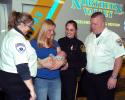 Jason Nicholas, Michelle Bisbing and Patrol Officer J. Angelone look at baby Camden, held by his mother Megan Poremba. The emergency services team delivered the baby in an ambulance while it was parked off Main Street in Slatington on lot Dec. 4.