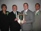 BILL O'GUREK/TIMES NEWS Tom McCarroll, second from left, receives the Shamrock Award from Billy O'Gurek Jr., second from right, Panther Valley Irish-American Association president, while looking on are the honoree's wife Michele and son, Tom Jr.,…