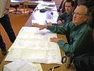 DONALD R. SERFASS/TIMES NEWS Dan Schroeder, Tamaqua community development director, explains details of the proposed Owl Creek playground at a bid opening meeting Wednesday at borough hall. On hand to provide additional information was, seen in…
